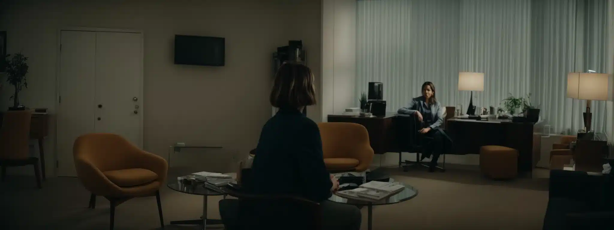 a therapist and an employee converse in a calm, private office setting.